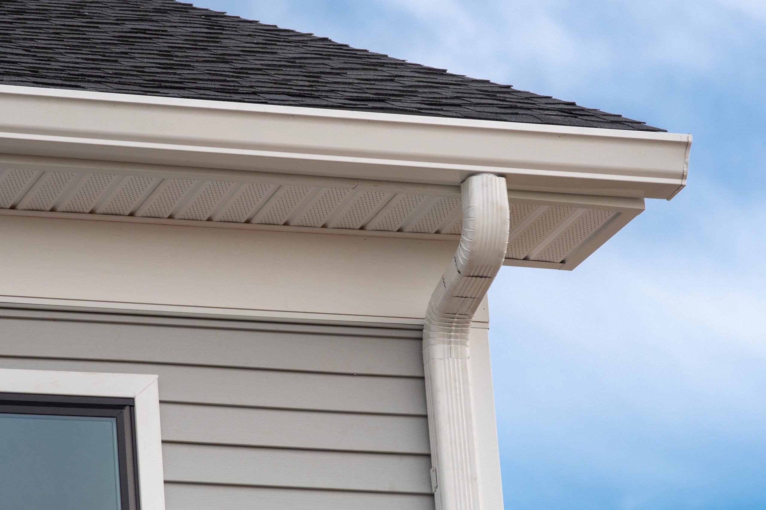 Close-up of Hardie Plank siding and gutter system on a residential home, highlighting expert installation by Joe Ochoa Roofs & Even More in Greater Houston.